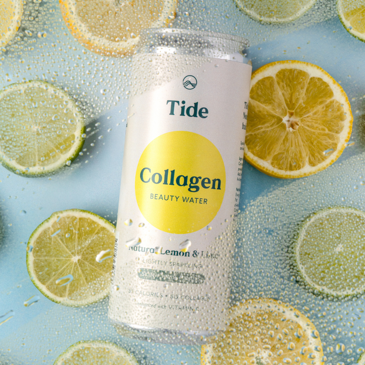 A can of Tide Collagen Beauty Water sparkling lemon and lime flavored collagen drink, surrounded by fresh lemon and lime slices on a light blue background with condensation droplets.